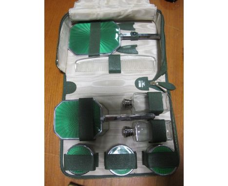 AN ART DECO EIGHT PIECE GENTLEMAN'S DRESSING SET with green enamel back in case
