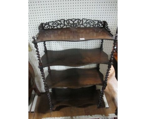 A VICTORIAN ROSEWOOD FOUR TIER WHATNOT of serpentine outline the shaped moulded top with pierced gallery each moulded shelf j