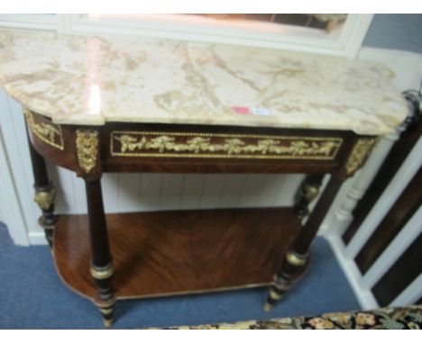 A CONTINENTAL MAHOGANY AND GILT BRASS MOUNTED SIDE TABLE surmounted with a sienna marble top of inverted breakfront bowed out