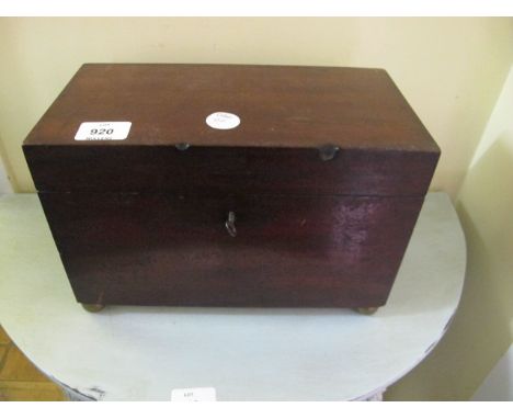 A GEORGIAN MAHOGANY TEA CADDY the rectangular hinged lid containing zinc containers lacking one lid raised on bun feet