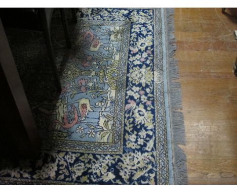 A WOOL RUG the light blue ground decorated with flowerheads, foliage and flamingos within a foliate and flowerhead border 185