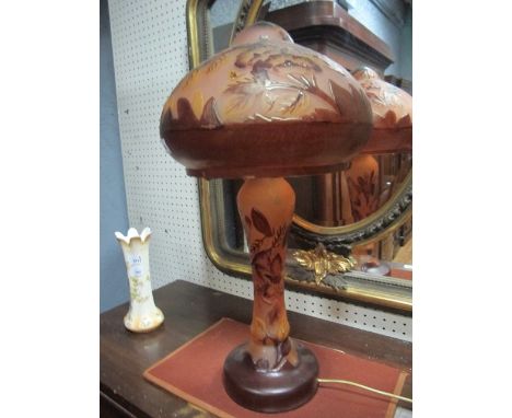A CONTINENTAL PINK AND RUBY ETCHED GLASS LAMP moulded in relief with flowerheads and foliage with mushroom shade and baluster
