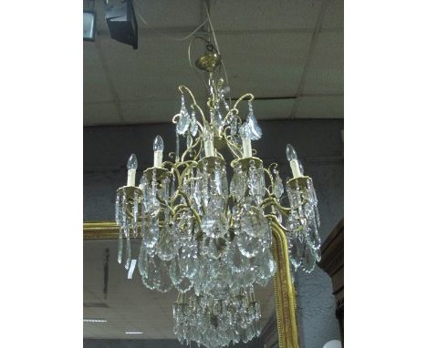 A FINE CONTINENTAL GILT BRASS AND CUT GLASS TWELVE BRANCH CHANDELIER hung with pendant drops 66cm drop