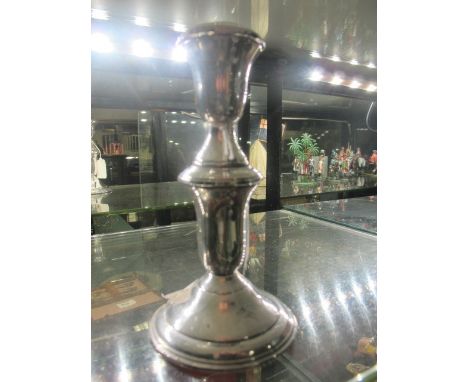 A STERLING SILVER CANDLESTICK with knopped column raised on a circular spreading foot