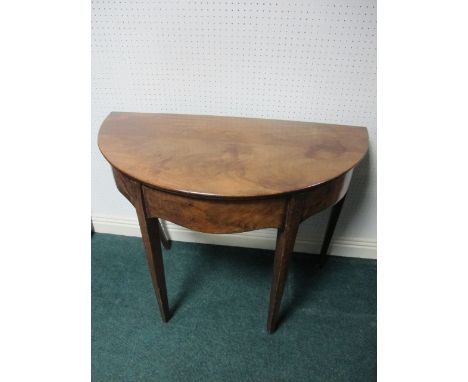 A GEORGIAN MAHOGANY SIDE TABLE of demi-lune outline the shaped moulded top above a plain frieze on square tapering legs 71cm 