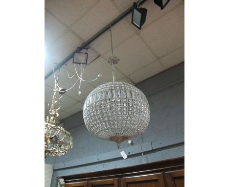 A CONTINENTAL CUT GLASS AND BRASS CENTRE LIGHT of bulbous form decorated with cut glass faceted pendants 90cm high