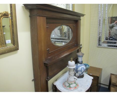 A c.1950 MAHOGANY CHIMNEY PIECE with oval bevelled glass mirror above a moulded shelf raised on rectangular jabs 183cm (h) x 