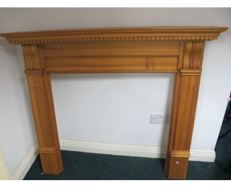 A PINE FIRE SURROUND the rectangular shelf with dentil moulded frieze raised on moulded jabs with scroll capital 124cm (h) x 