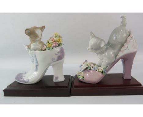 Two Lladro cats in shoes with flower posy figurines on wooden bases. 6 1/4" tall.