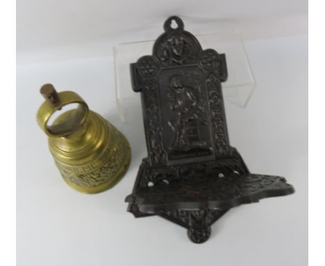 Cast iron wall mounted shelf and a brass bell.