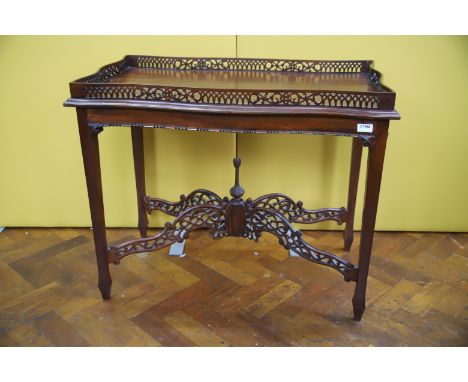 Vintage Galleried topped Mahogany table with pierced X frame cross members.  H:28 x W:34 x D:19 inches. See photos. 