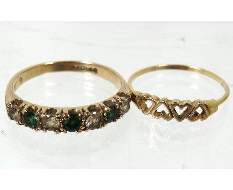 Two 9ct Gold rings, one with pierced heart motif, the other 9ct ring is set with clear and Green Gemstones. Total weight is  