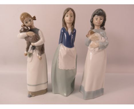 Two Nao and one Lladro figurines of girls, two which are holding animals, the tallest measures, 9 1/4".