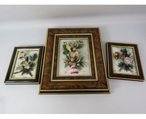 Three framed Capodimonte ceramic wall hangings Flowers and birds, the largest measures 14" by 11.5".