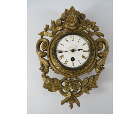 Antique cast metal french wall clock with enamel face, runs intermittently. 10.5" long & 8.5" wide.