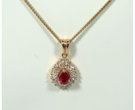 18ct Yellow Gold Ruby and Diamond Pendant hung on an 18 Inch, 18ct Gold Chain. Pendant measures approx 19mm.  Total Weight 4.