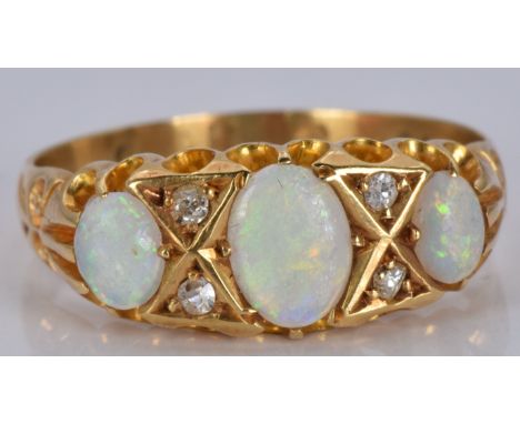 An 18ct gold ring set with three opals and diamonds, 2.9g, size M