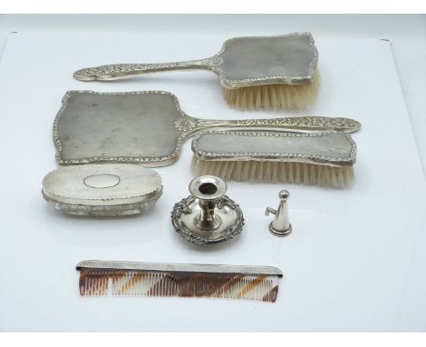 Elizabeth II hallmarked silver dressing table set with floral embossed decoration, comprising hand mirror and two brushes, Bi