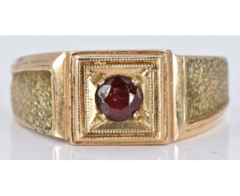 A 9ct gold signet ring set with a garnet, 6.8g, size T&nbsp;