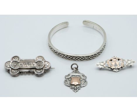 A silver bangle, Victorian brooch (Birmingham 1898), silver sweetheart brooch (Glasgow 1938) and a silver fob&nbsp;