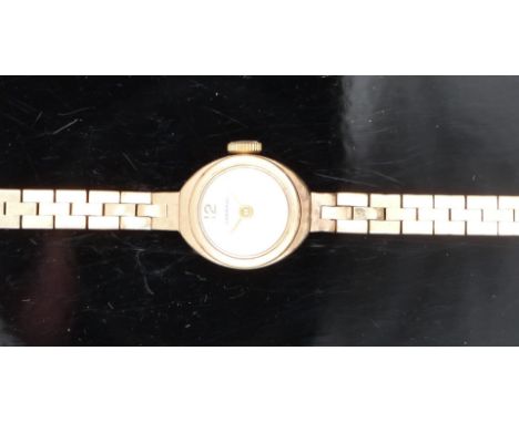 Garrard 9ct gold ladies wristwatch with gold hands and hour markers and silver dial, on 9ct gold bracelet, case diameter 14mm