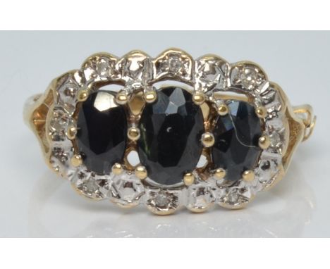A 9ct gold ring with three oval cut sapphires surrounded by diamonds, 2.4g, size M&nbsp;