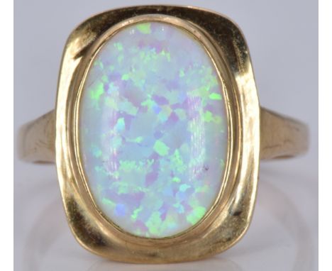 A 9ct gold ring set with a synthetic opal, 3.8g, size M/N