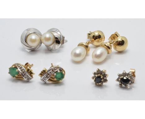 A collection of 9ct gold earrings including a white gold pair set with a pearl, emerald and diamond etc (7.1g)