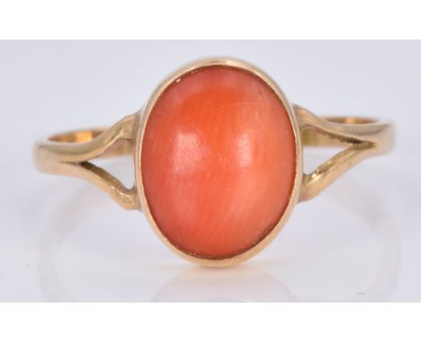 An 18ct gold ring set with a coral cabochon, 1.7g, size M