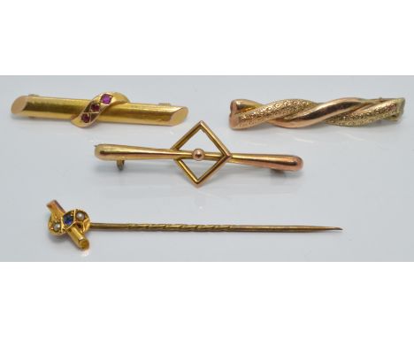 A 15ct gold brooch set with three rubies (2.1g),a 15ct gold stick pin set with a sapphire and seed pearls and two 9ct gold br