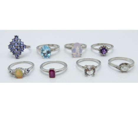 Eight silver rings set with ametrine, tanzanites, ruby, zircon, itinga petalite, lavender quartz, opal, blue sapphire, topaz 