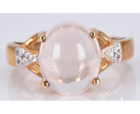 A 9ct gold ring set with a morganite cabochon and diamonds, 5.2g, size M