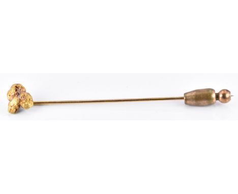 A stick pin set with three yellow metal nuggets, 3g