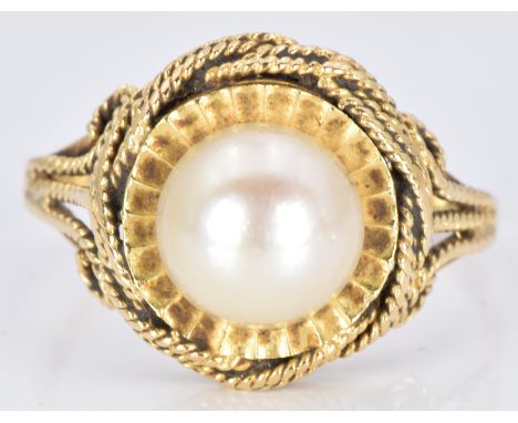 An 18ct gold ring set with a pearl, 4.3g, size M/N