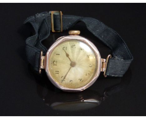 Rolex 9ct gold ladies wristwatch with gold hands, black Arabic numerals, engine turned silver dial and signed movement, on bl
