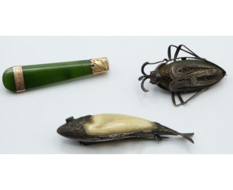 A silver brooch set with a beetle with ruby eyes, nephrite jade brooch with yellow metal mounts and a fish brooch