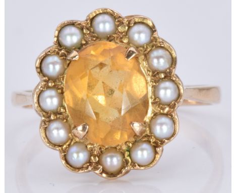A 9ct gold ring set with an oval cut citrine surrounded by pearls, 4.2g, size R