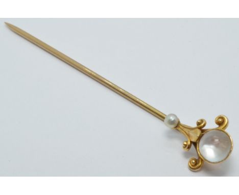 A continental 14k gold stick pin set with a moonstone and seed pearl, length 6cm, 2.1g