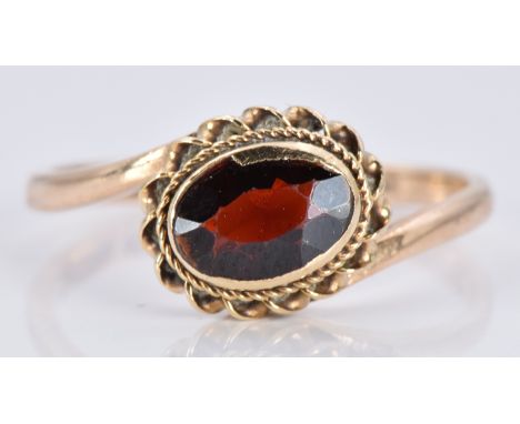 A 9ct gold ring with a garnet, 1.6g, size K