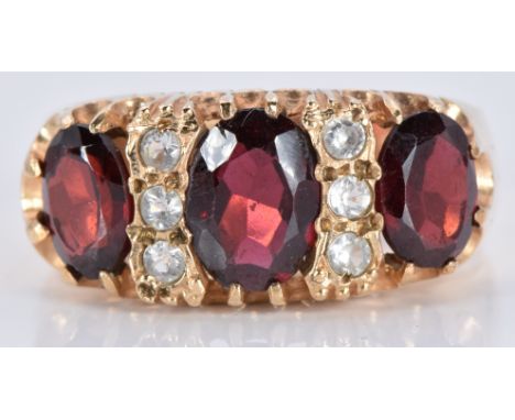 A 9ct gold ring set with three oval garnets and cubic zirconia, 5.0g, size Q/R