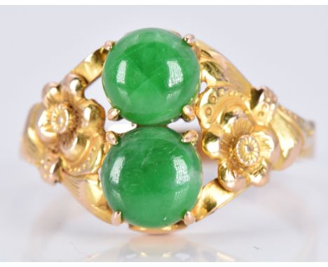 A 14k gold ring set with two jade cabochons with floral embossed shoulders, 3.1g, size O