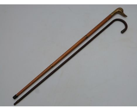 A walking cane with hallmarked silver mounts, London 1916, and a walking stick with brass duck head, screw top and drinking v