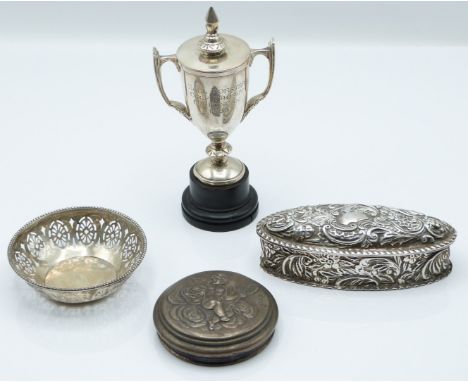 Hallmarked silver items comprising small twin handled trophy cup on ebonised base, Victorian embossed trinket box, Chester 18