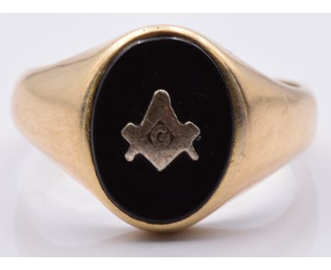 A yellow metal ring set with onyx and a Masonic symbol, 3.4g, size R