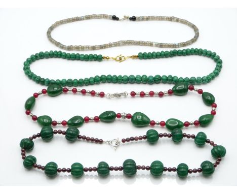 An emerald and jade necklace, quartz and garnet necklace, labradorite necklace, and a quartz necklace&nbsp;