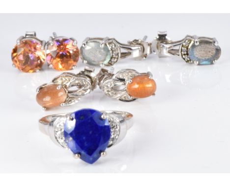 A silver ring set with a pear cut lapis lazuli and zircons and three pairs of silver earrings set with labradorite and topaz,