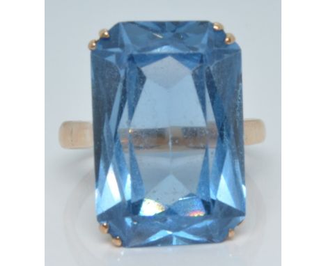 A 14k gold ring set with a large emerald cut blue topaz, 8.3g, size R