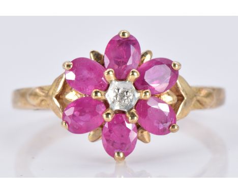 A 9ct gold ring set with oval rubies and a diamond in a flower cluster, 2.6g, size N