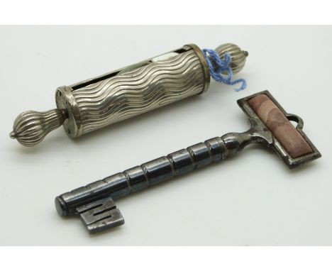 A 19thC steel needle case in the form of a key with agate finial and a tape measure, longest 9cm