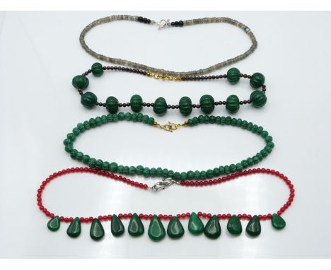 A labradorite necklace, jade and quartz necklace, garnet and quartz and another quartz necklace